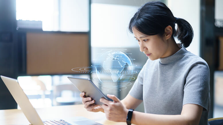 Woman at laptop with globe