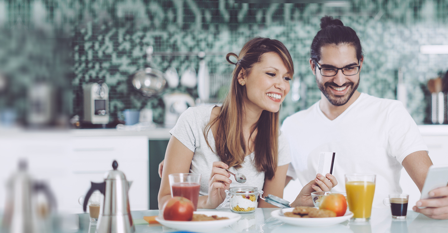 Couple reviewing an app on a tablet in a kitchen